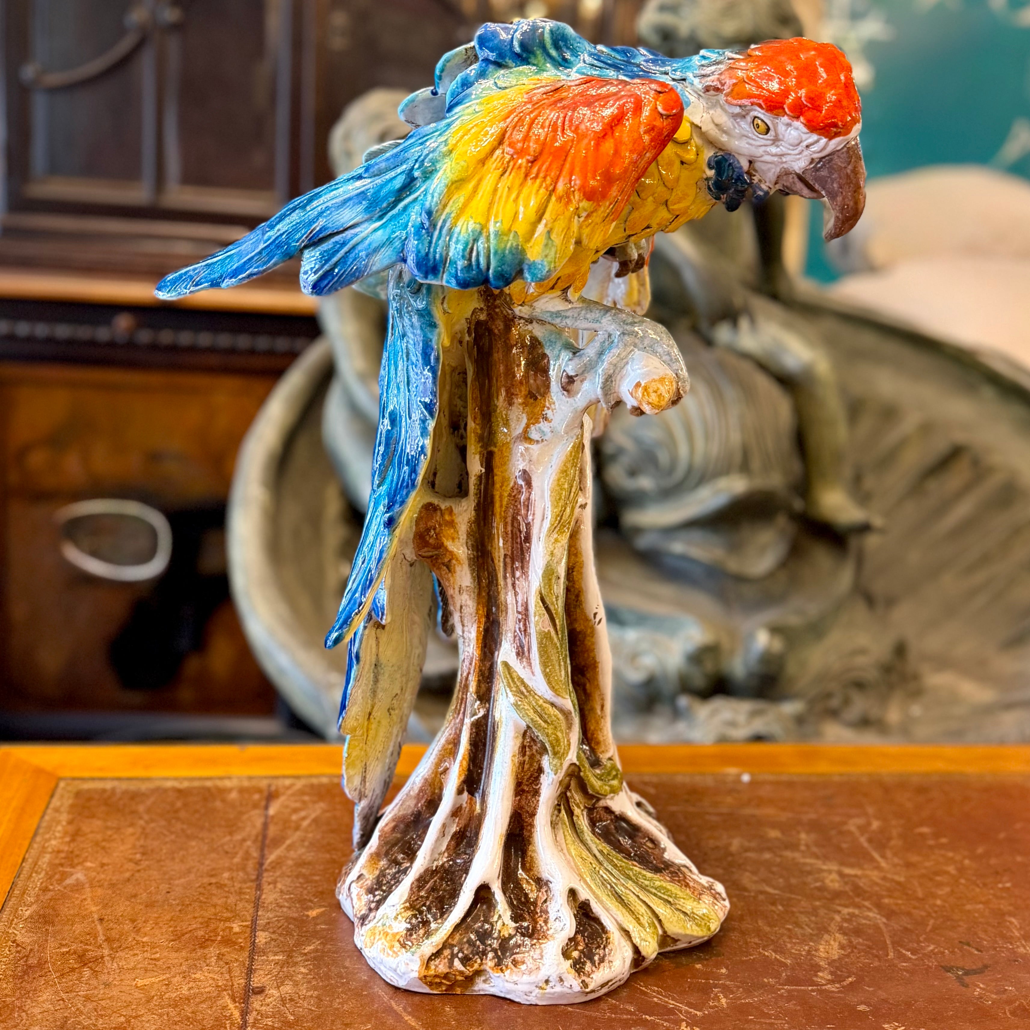 Espectacular guacamayo de mayólica italiana posado en una tronco. Italia 1930
