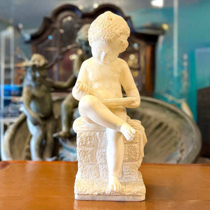 Escultura de alabastro de un "putti" niño leyendo tranquilamente. Italia SXIX